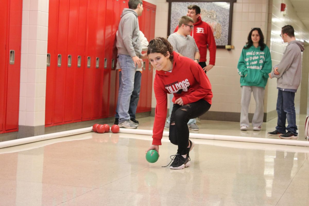 Looking to the future: Preparing for their game, junior Hailey Stinar rolls for her team during practice on Dec. 12. The eight members of the team split into two teams during practice so that they can simulate games. 