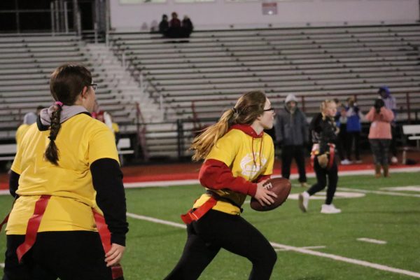 On the move: After snapping the ball, freshman Rylie Vojtko hands the ball off to other freshman Tessa Wright as she proceeds to run down the field. Handing off the ball to another player gives the offensive team a chance to run the ball down the field and score. 
