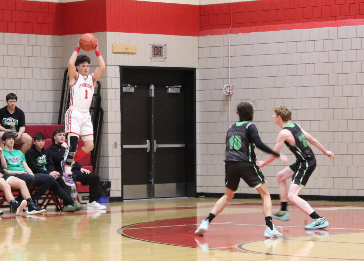 Above and beyond: Leaping up, senior Logan Bickerstaff grabs the ball during the team’s home game against Riverside on Jan 12. The team showcased their new skill sets as they fought to gain control of the match.