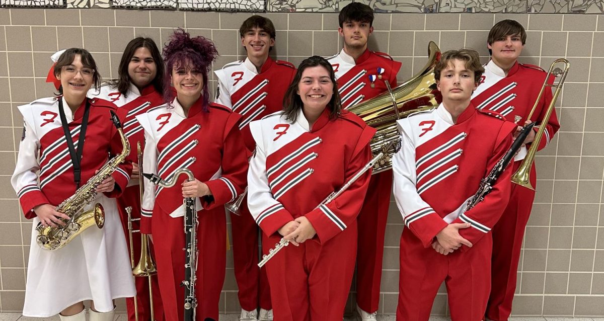 Ready to perform: (Front, left to right) Calla Reynolds, Hailey Stinar, Lilly Burgess, Joseph Castelli, (back) Dakota Gingerella, Elias Boyd, Jesse Reinhardt and Johnathan Bruce smile with
their instruments before their performance. For the first time since the COVID-19 pandemic, the county band festival was held. Band directors from across the county nominated instrumentalists
to be a part of the festival.