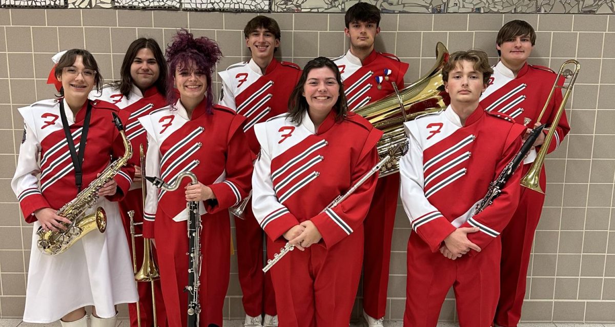 Ready to perform: (Front, left to right) Calla Reynolds, Hailey Stinar, Lilly Burgess, Joseph Castelli, (back) Dakota Gingerella, Elias Boyd, Jesse Reinhardt and Johnathan Bruce smile with
their instruments before their performance. For the first time since the COVID-19 pandemic, the county band festival was held. Band directors from across the county nominated instrumentalists
to be a part of the festival.