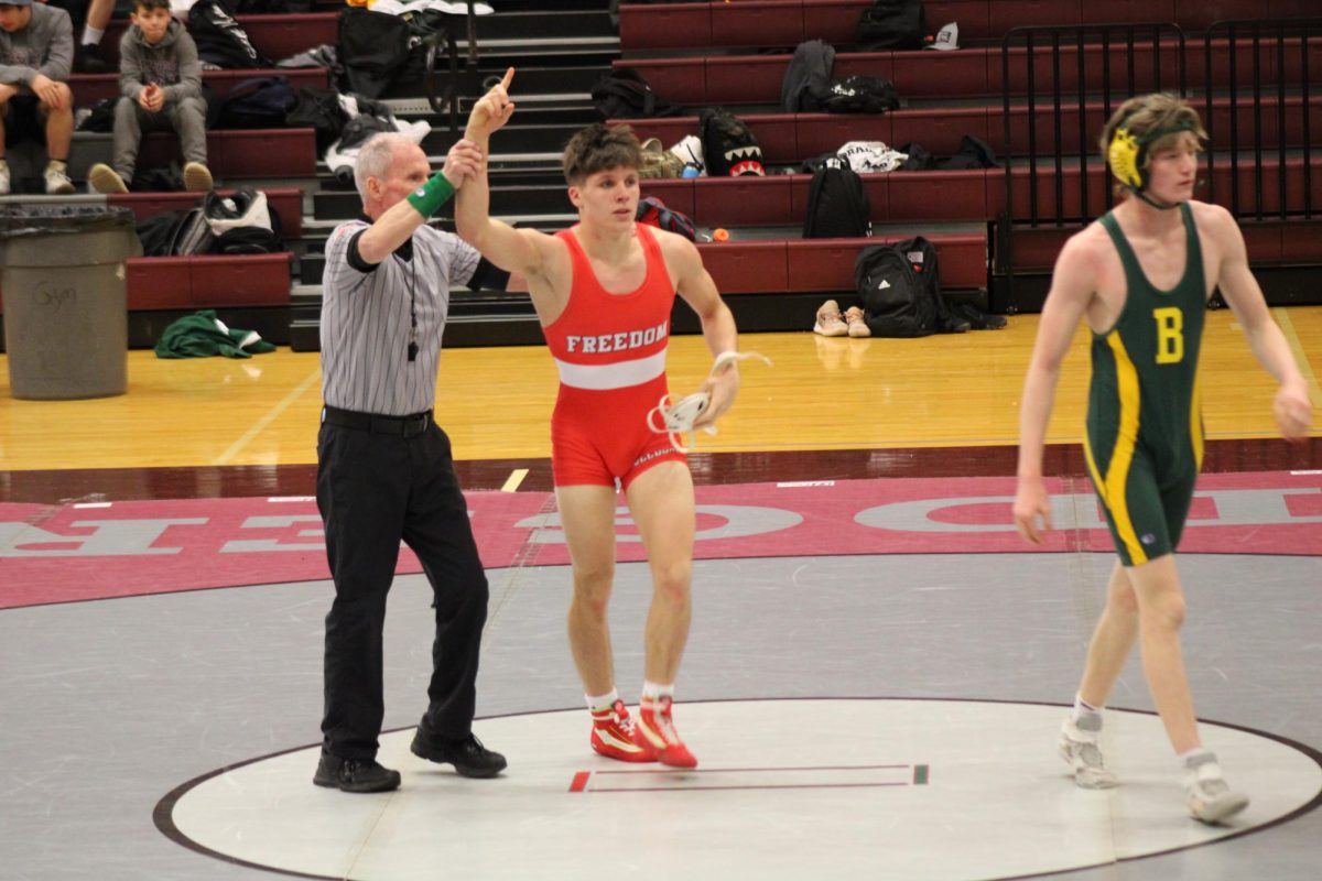 For the win: with his victory hand in the air, senior Ryan Kredel wins his match against a SouthSide BeaverOpponent. The team had an overall victory against SouthSide Beaver.