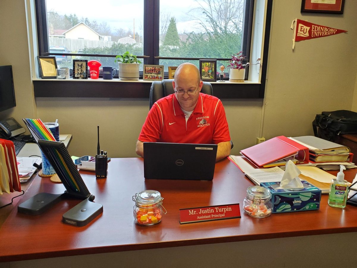 Working diligently: Typing on his Chromebook, Mr. Justin Turpin works on assignments given to him as assistant
principal. On top of digital work, the assistant principal helps out with various tasks throughout the school.