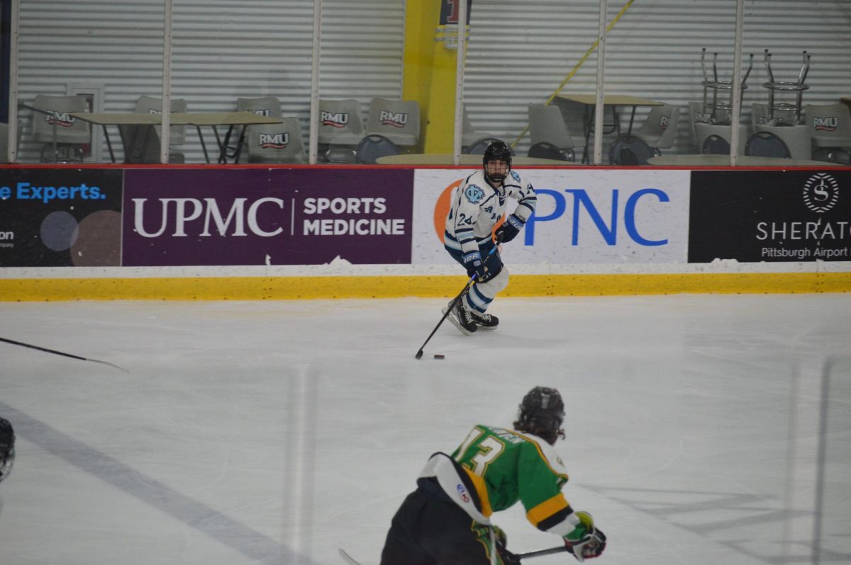 Shooting stance: Carrying the puck down the ice, senior Aiden Pournaras looks for a goal on the net at his All-Star hockey game at Robert Morris ice rink. Three students from Central Valley got to play in teh sectional All-star game. 