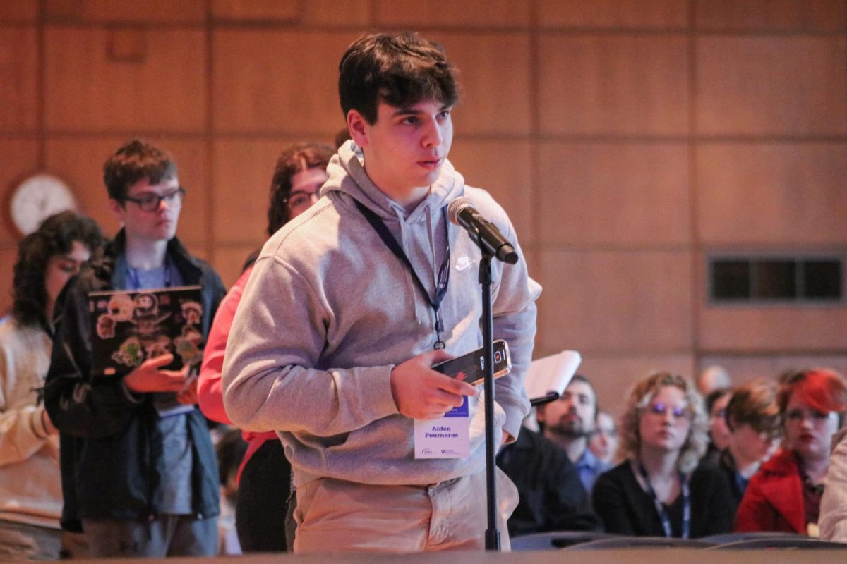 Pressing record: Asking a question, senior Aiden Pournaras talks to an interview subject. For the competition, student journalists interviewed Assistant Athletic Director for Creative Content and Branding, Sarah Higgins, to get information about her job at Penn State. 