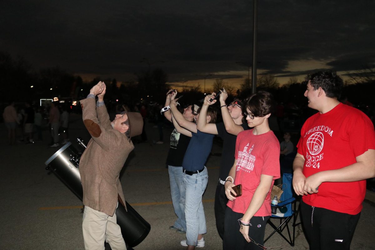 Taking in the totality: Viewing the eclipse, students take pictures of the eclipse totality. When totality occurred, the area around the eclipse became dark for several minutes.

