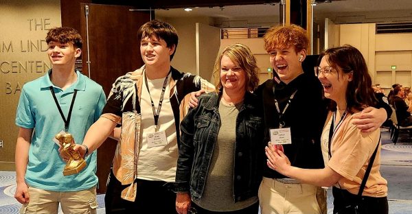 With Awards: Laughing, students who competed in the Academic Games competition and Ms. Jennifer Glover pose for a picture together. Sophomore Calla Reynolds placed top ten individually and was a part of a top six team. Noah Brandon was a part of the first place Current Events team.