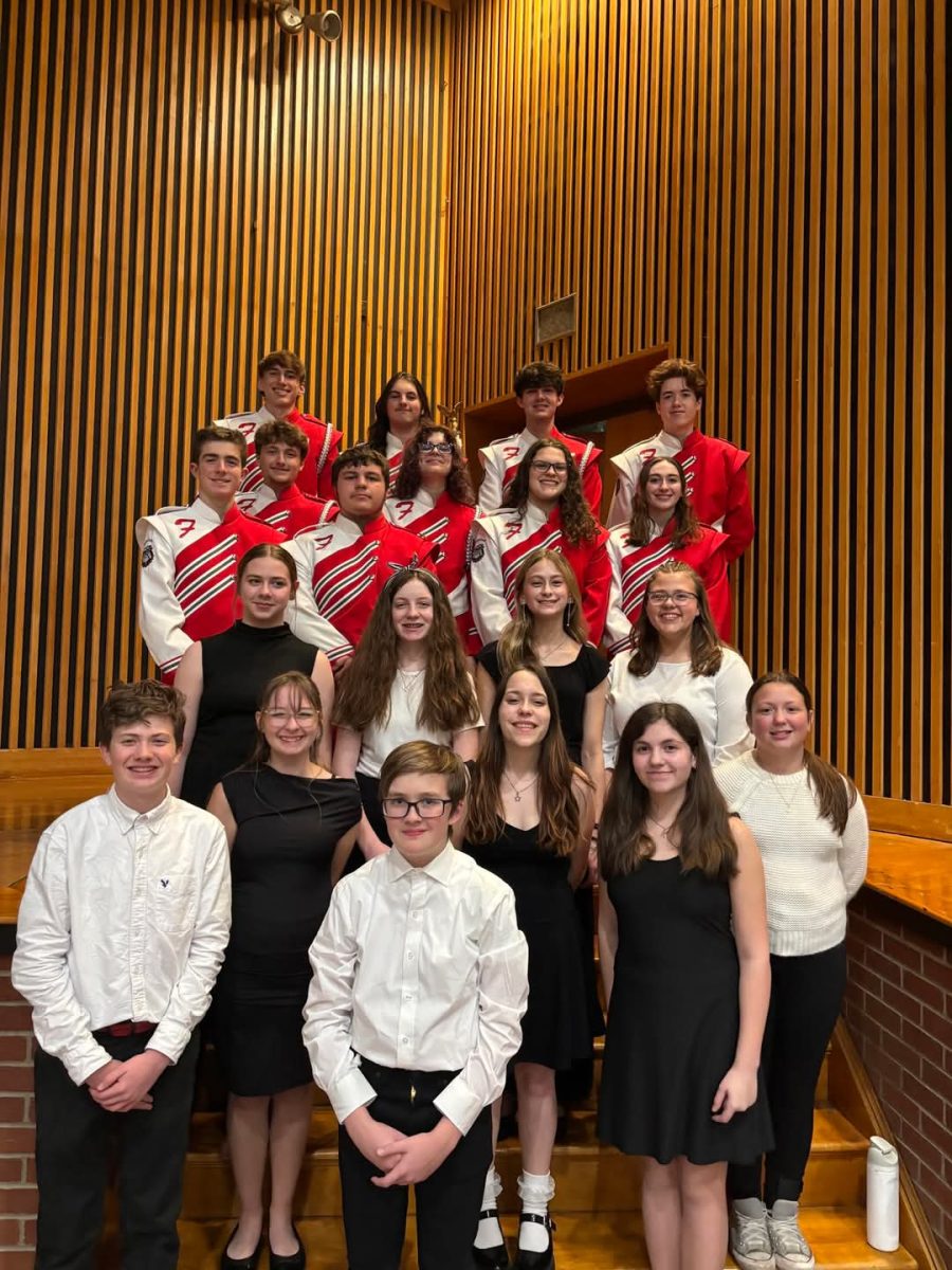Dressed to represent: Students from the middle and high school band pose together for a photo. Twenty band students from the district attended this event.