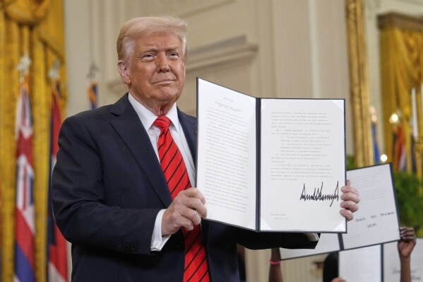 Educational evaluation: Raising his new executive order, President Donald Trump presents his updated policies to the press. This executive order in particular effectively shut down the Department of Education, permitting the government to focus more resources on defense or homeland security.