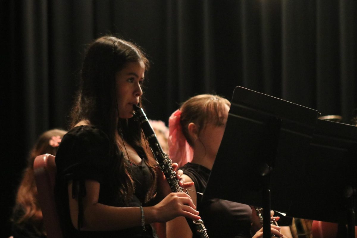 Masterful melody: At the annual spring concert, Ashley Benavidez-Martinez (9) diligently watches the director. To stay in tune with one another, instrumentalists must continously listen to their peers and adjust their own sound from there. 