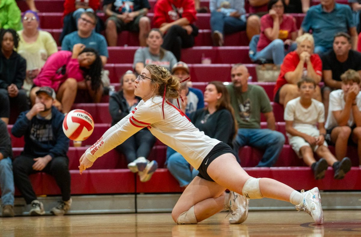 Hitting the floor: Going for the ball, Tessa Wright (11) dives in hopes of saving the rally and winning Freedom the point. While many positions vary in rules, Libero is the only position that can substitute freely during the game.