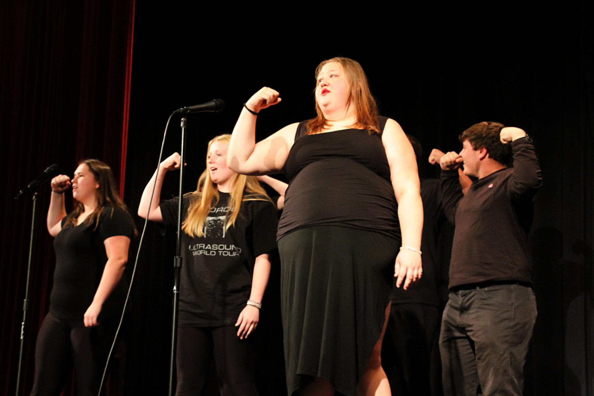 Singing seniors: As the lights shine on them, seniors Abigail Hunter, Hannah Shaffer, and Phoebe Smith perform "When I Grow Up," a number from the musical "Matilda." They chose to perform the song because every returning senior performed in Matilda during the 2023-2024 school year.