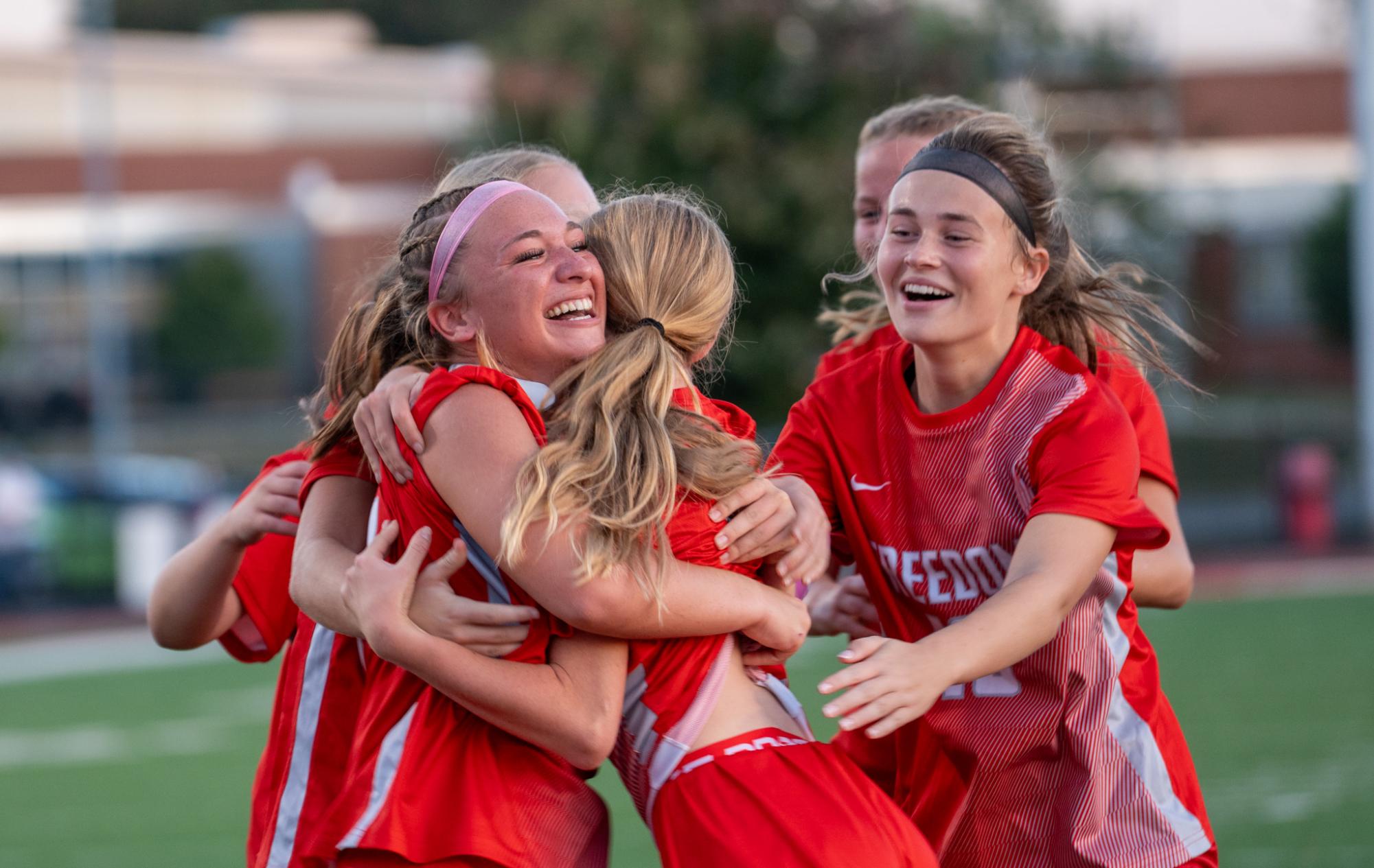 Warm embrace: Wrapping Katelyn VanDeCar (9) in her arms, Alyssa Bearer (12) gives her teammate a big hug after scoring a goal. In every possible moment, the team celebrated small wins on the field, always cheering up their fellow teammates.