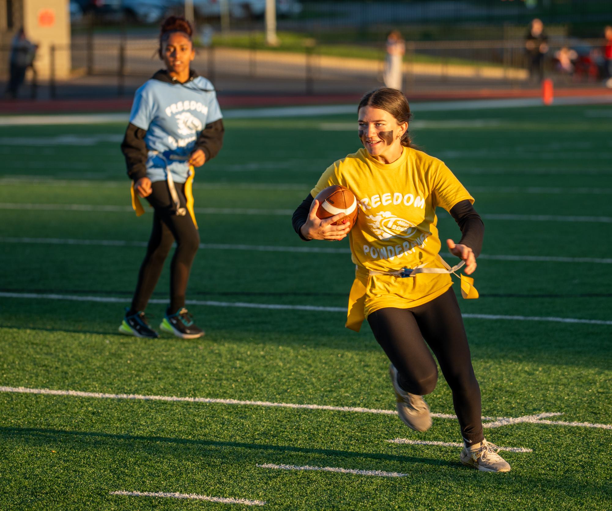 Dash to the endzone: Holding the ball in her arm, Jordyn Moehrle (9) darts down the field. Moehrle secured the most touchdowns for underclassmen, being the most prominent contributer to her team's victory.