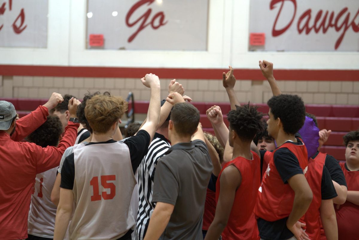 Unity on the court: Before the team scrimmages against each other, they huddle to have a motivating talk. The huddle boosts their energy and gets everyone hyped up for a competitive scrimmage.