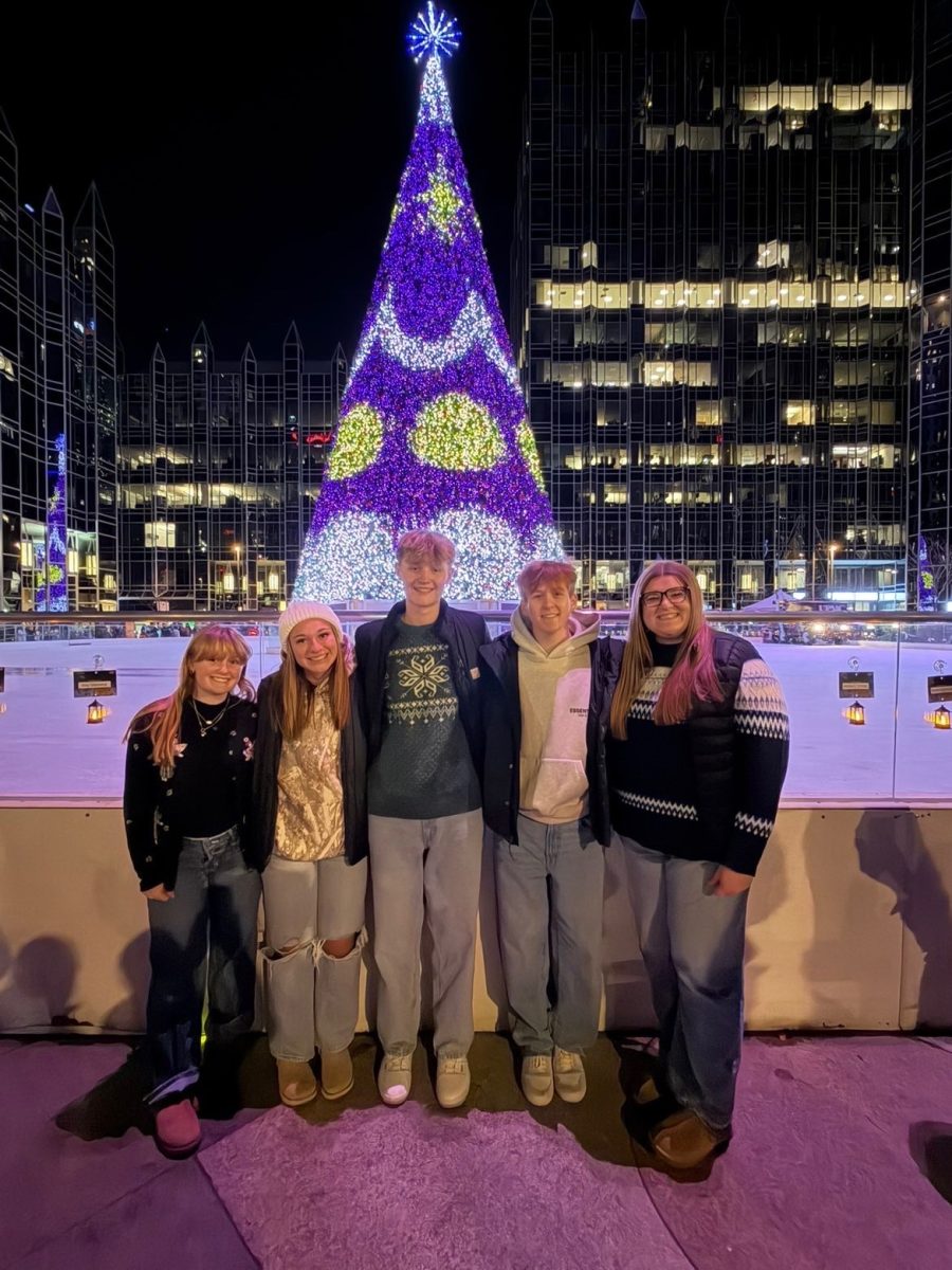 O Tannenbaum: A group of friends stands around the large Christmas tree at the UPMC Ice Rink at the PPG Place. Skating at the rink has become a tradition for many, with huge crowds throughout the entirety of the day.

