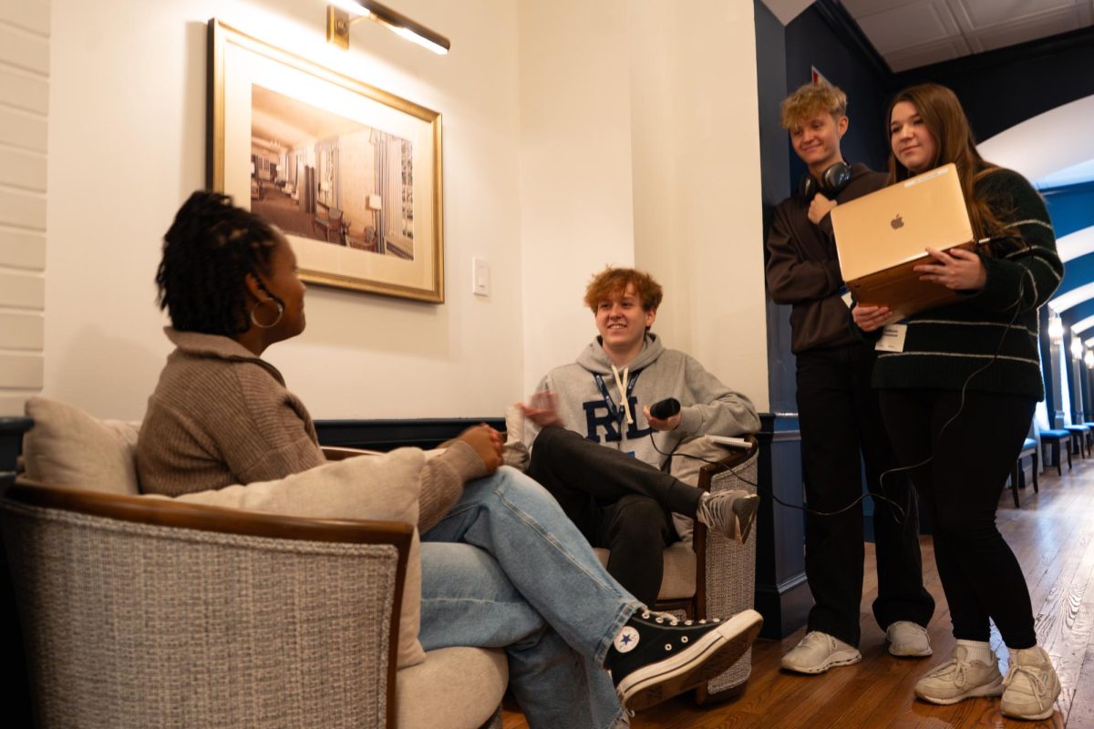 Podcast partners: Colton Blank (12), Caden Beringer (12) and Addison Freeman (12) listen to a Penn State student as she talks about her experience sitting on a panel for the journalism competition. The theme for this year's competition was residence life.