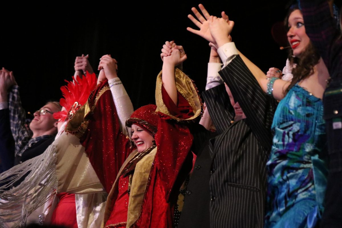 Final bow: Lead actors and actresses gather at the front of the stage to take their final bow on Sunday, March 8. Immediately following this, the cast helped the technical crew and parent volunteers disassemble the set. 